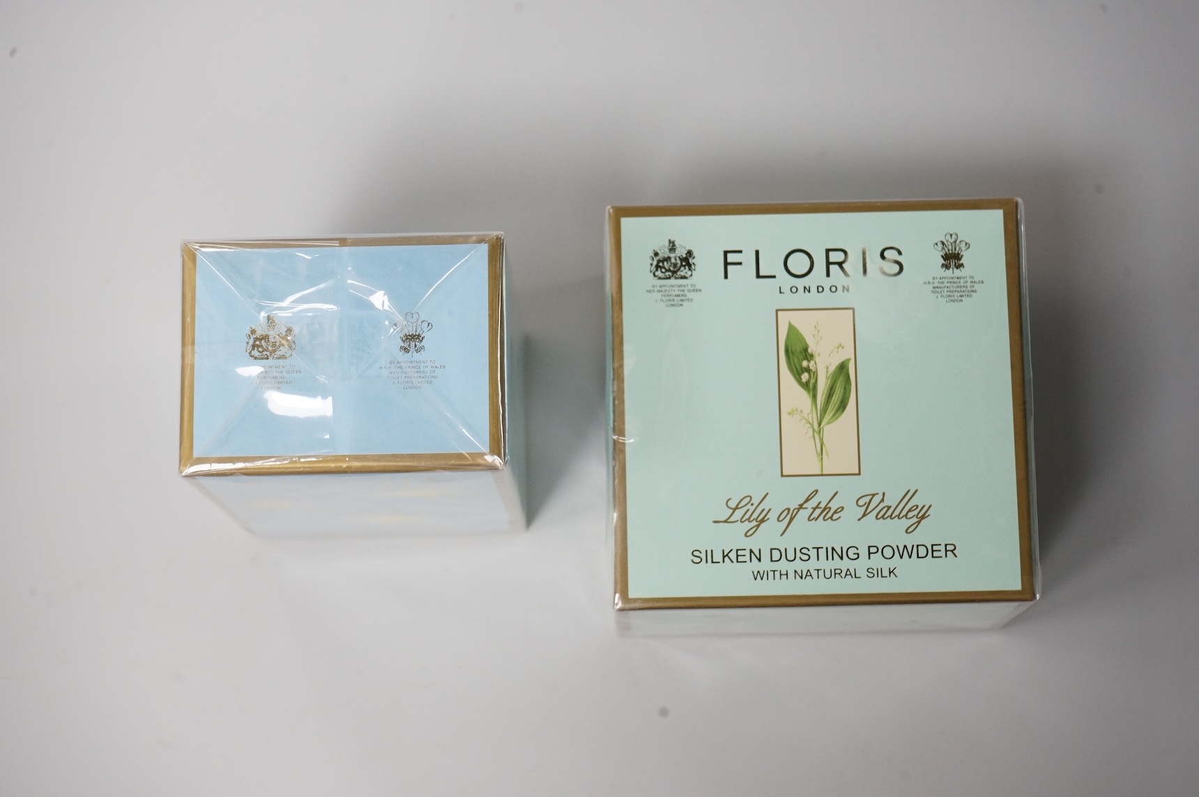 Three bottle of ladies unopened Floris perfumes comprising two bottles of Fleur and one bottle of Special No. 127, together with Floris Lily of the Valley silken dusting powder, each boxed and cellophane wrapped